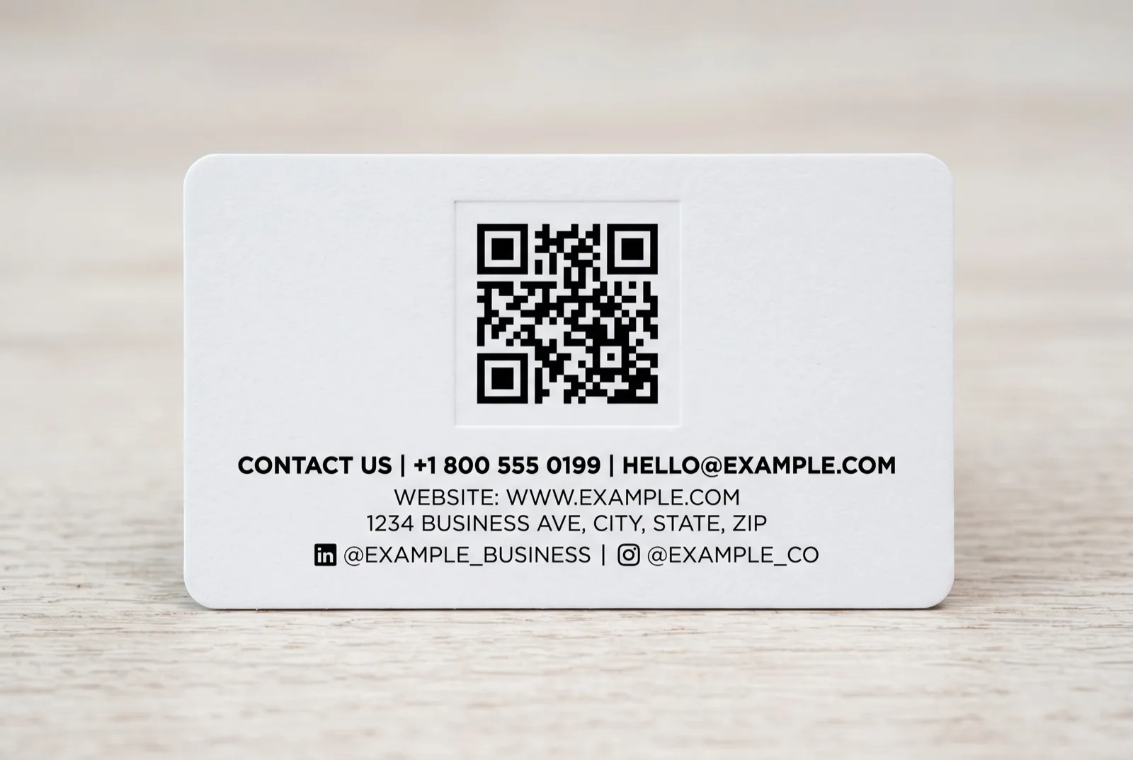 Back of a networking card showing a scannable QR code with clear margin, a primary phone number, and a short URL in a clean hierarchy